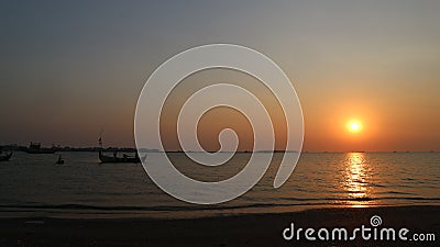 Sunset approaching the night, boat silhouette on the beach Stock Photo