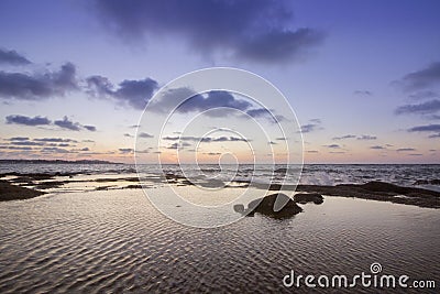 Sunset Atlantic Ocean view at Dar Bouazza rocky beach Stock Photo