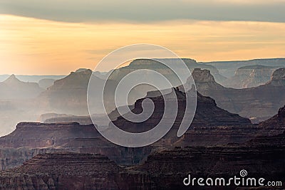 Sunset Begins to Light Up the Layers of the Grand Canyon Stock Photo