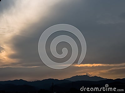 the sunset behind the mountain, the sky and the beautiful clouds shine Stock Photo