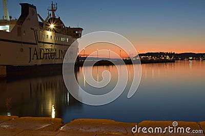Sunset with boat waiting to leave the port Editorial Stock Photo