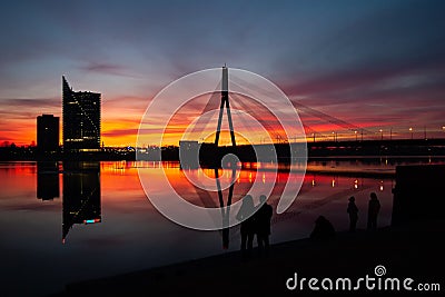 Sunset at the bridge on the Daugava River in Riga Stock Photo