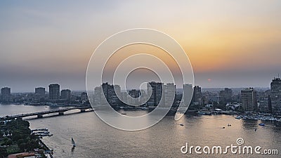 Sunset in Cairo. The sun is low in the blue-orange sky. Stock Photo