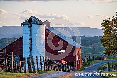 Sunset at Cattle Farm + Red Barn with American Flag - West Virginia Stock Photo