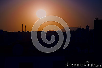 Sunset on the city of Agadir Morocco with antennas and minaret Stock Photo