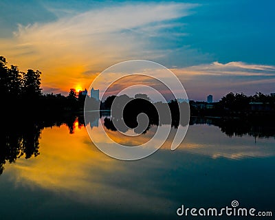 Sunset on city lake Stock Photo
