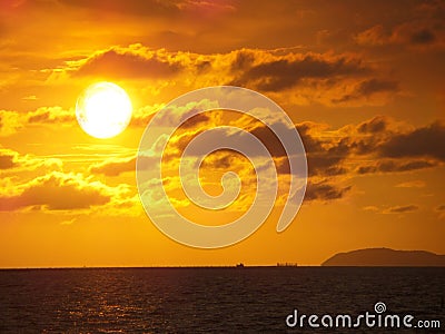 Sunset and cloud gold color over sea in evening Stock Photo