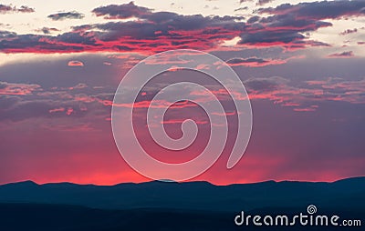 Sunset and clouds over dark mountains at Dinosaur National Monument Stock Photo