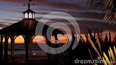 Sunset cloudscape, gazebo on beach, twilight dusk, dramatic sky. Alcove and vane Stock Photo