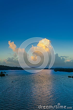 Sunset cumulus clouds on tropical horizon. Stock Photo