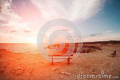 Sunset in Cyprus - Mediterranean Sea coast. Sea Caves near Ayia Napa. the bench in the background of space. you can sit Stock Photo