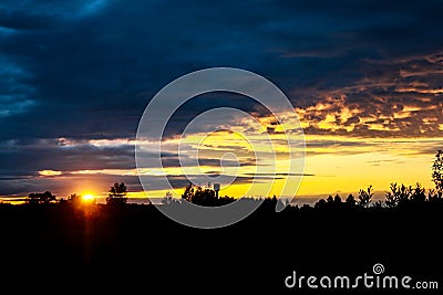 The sunset in the dark forest Stock Photo