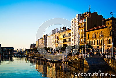 Sunset in the dock of Gijon, Asturias, Spain, with the reflections of the buildings in the water. Relaxing place Editorial Stock Photo