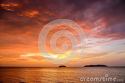 Sunset with dramatic clouds on the tropical beach Stock Photo