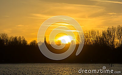 Sunset dutch lake and church. Stock Photo