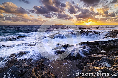 Sunset at El Bufadero natural blowhole on Gran Canaria. Ocean waves hiting rocks Stock Photo