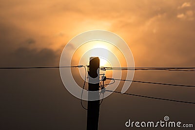 Sunset and Eletricity line and electricity post Stock Photo