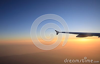 Sunset flight view with airplane wing silhouette Stock Photo