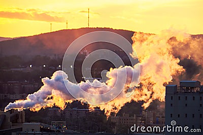 Sunset in the fog of a small industry Stock Photo