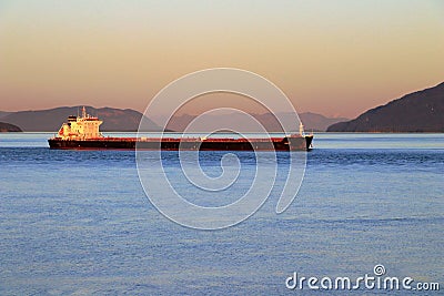 Freighter Ship in Rosario Strait at Sunset, Saturna Island, British Columbia, Canada Editorial Stock Photo