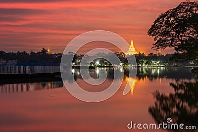 Sunset in the front of the lake, view of Shwedagon Pagoda, Yangon, Myanmar. Burma Asia. Buddha pagoda Stock Photo