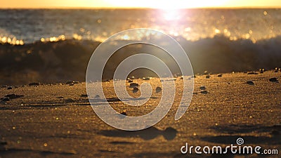 Sunset in Greece on a Beach with Sand in the foreground Stock Photo