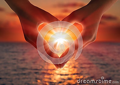 Sunset in heart hands Stock Photo
