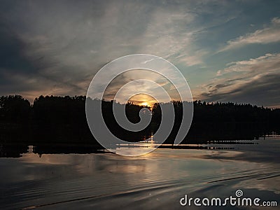Sunset on the lake. beautiful colors. chaotic clouds Stock Photo
