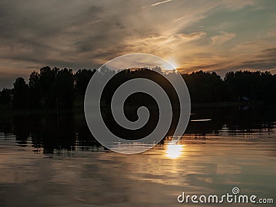 Sunset on the lake. beautiful colors. chaotic clouds Stock Photo