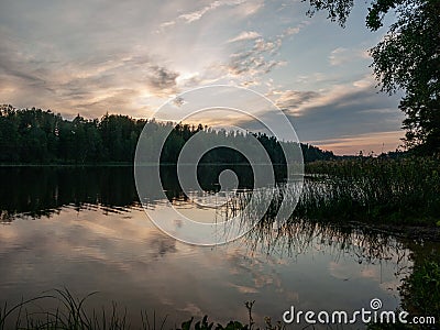 Sunset on the lake. beautiful colors. chaotic clouds Stock Photo