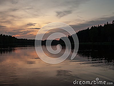 Sunset on the lake. beautiful colors. chaotic clouds Stock Photo