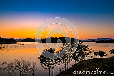 Sunset at lake Kaeng Krachan Dam on Silhouette Stock Photo