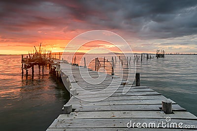 Sunset landscape of artisanal fishing boats in the old wooden pier Stock Photo