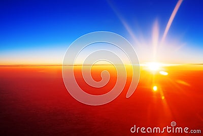 Sunset landscape, colorful sunrise over planet Earth, blue sky, bright yellow sun light rays red sunbeams, vibrant cosmic sunlight Stock Photo