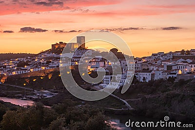 Sunset landscape in Mertola. Medieval city called Mertola in Alentejo, Portugal. Medieval castal on top of the hill in center of Stock Photo
