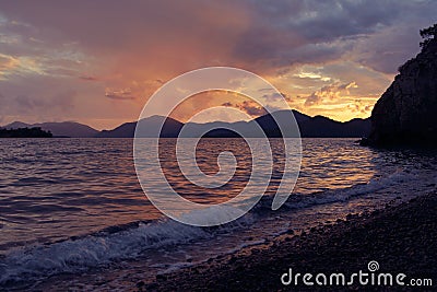 Sunset landscape, seashore, waves in the rays of the setting sun Stock Photo