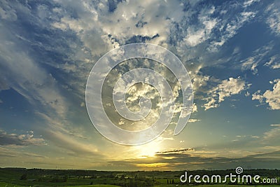 Sunset landscape with sky and clouds, green grass spring. Wide. Stock Photo