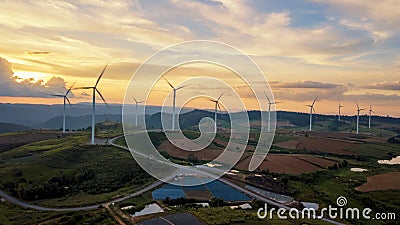 Sunset landscape Wind turbines farm clean green energy for elect Stock Photo