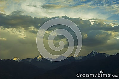 A sunset light on mountains snowy peaks Stock Photo