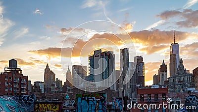 Sunset light shines behind the buildings of the lower Manhattan skyline in New York City Editorial Stock Photo