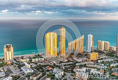 Sunset lights over Miami Beach buildings, helicopter view Stock Photo