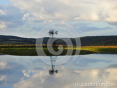 Sunset lights up a geothermal farm pond in FingerLakes Stock Photo