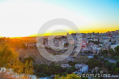 Sunset at lookout of Toledo, Spain. Tajo river around the city and Alcazar and Cathedral at background. Stock Photo