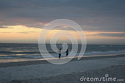 Couple viewing the sunset at Madiera Beach, St Pete Florida Editorial Stock Photo