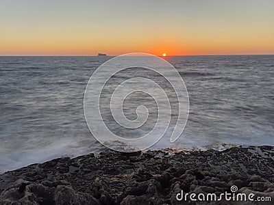 Sunset on the Mediterranean Sea with a far away seen island Stock Photo