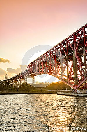 Sunset at the Minato Bridge red bridge in Osaka crossing over Stock Photo