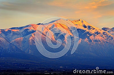 Sunset on Mountain Top in Winter Orange Beautiful Light Stock Photo