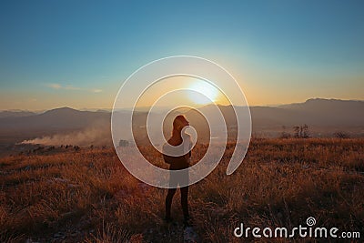 Sunset mountain. Tourist Free happy woman outstretched arms wit Stock Photo