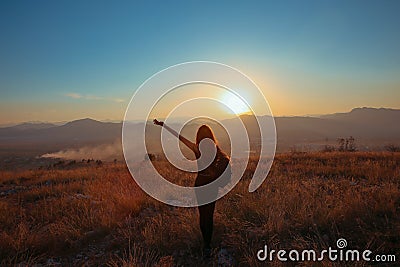 Sunset mountain. Tourist Free happy woman outstretched arms wit Stock Photo