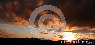 Sunset on Mountains Horizon Clouds Sunstar Sun star Glowing in the Valley Stock Photo